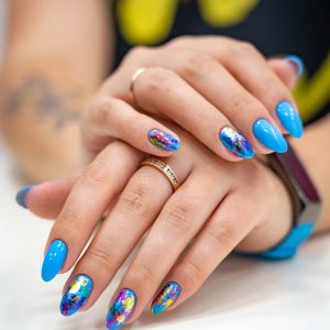 lot of color gloss manicure hand has different blotches in a light background